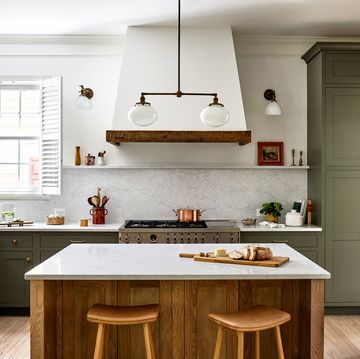 kitchen with green cabinets and a kitchen island in the center