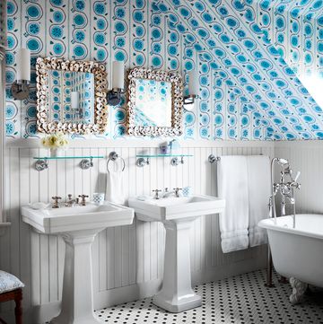 white preppy bathroom with blue wallpaper