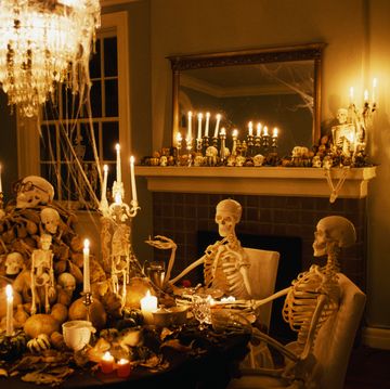 skeletons sits at a dining room table during a halloween party at the home of william joyce, well known childrens writer and illustrator