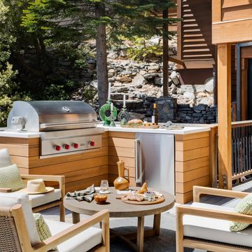 a corner cabinet and undercounter fridge boost the utility of this grilling area by designer jen samson