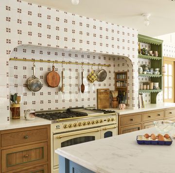 white tiled kitchen with brass pot rail