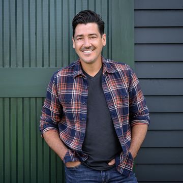 jonathan knight in front of the restored barn at his new england farmhouse, as seen on farmhouse fixer