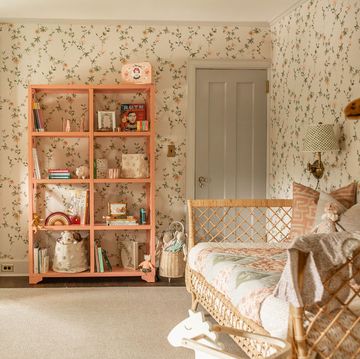 nursery, floral wallpaper, green curtains, day bed, peach bookshelf, rocking chair, children's toys