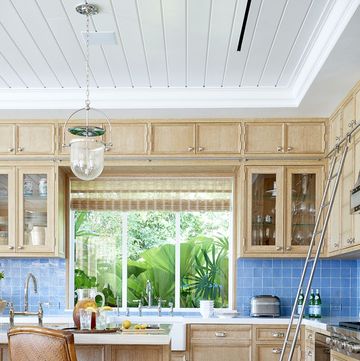 beachy light wood kitchen with blue tile backsplash